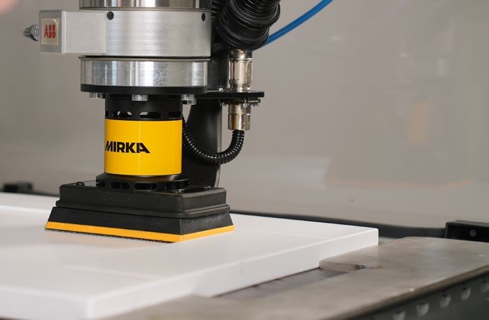Mirka AIROS 353S orbital sander on a robot, sanding a flat white panel