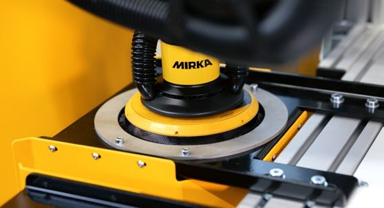 Mirka sander picking up a fresh disc from the AutoChanger magazine
